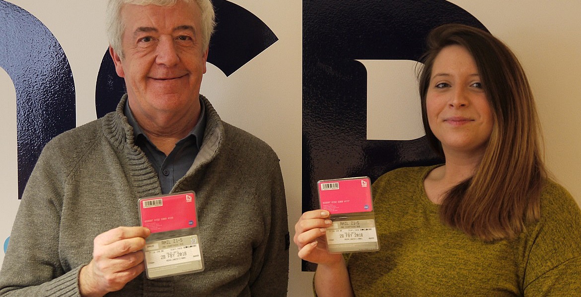 Bob and Natalie proudly show off their travel passes
